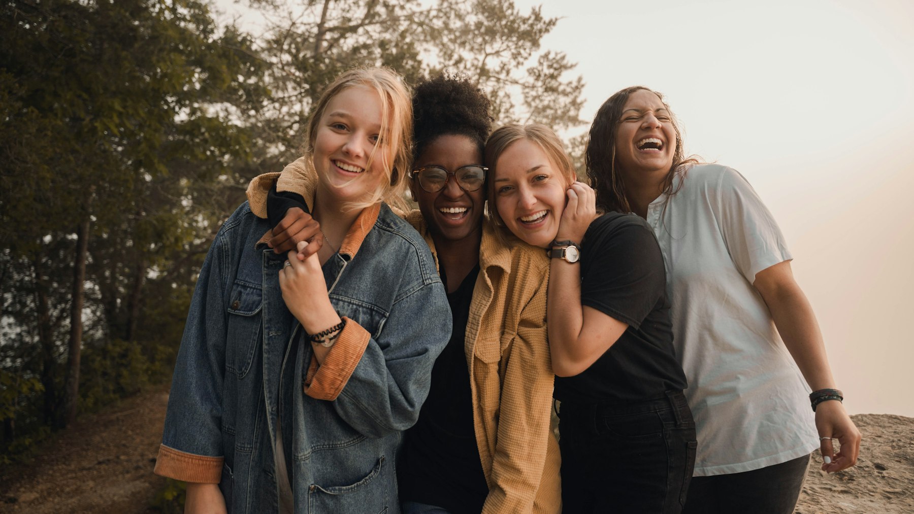 Four friends laughing together